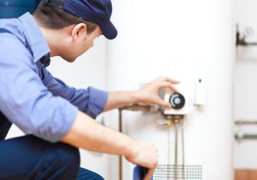 plumber doing maintenance on a water heater plumber doing maintenance on a water heater
