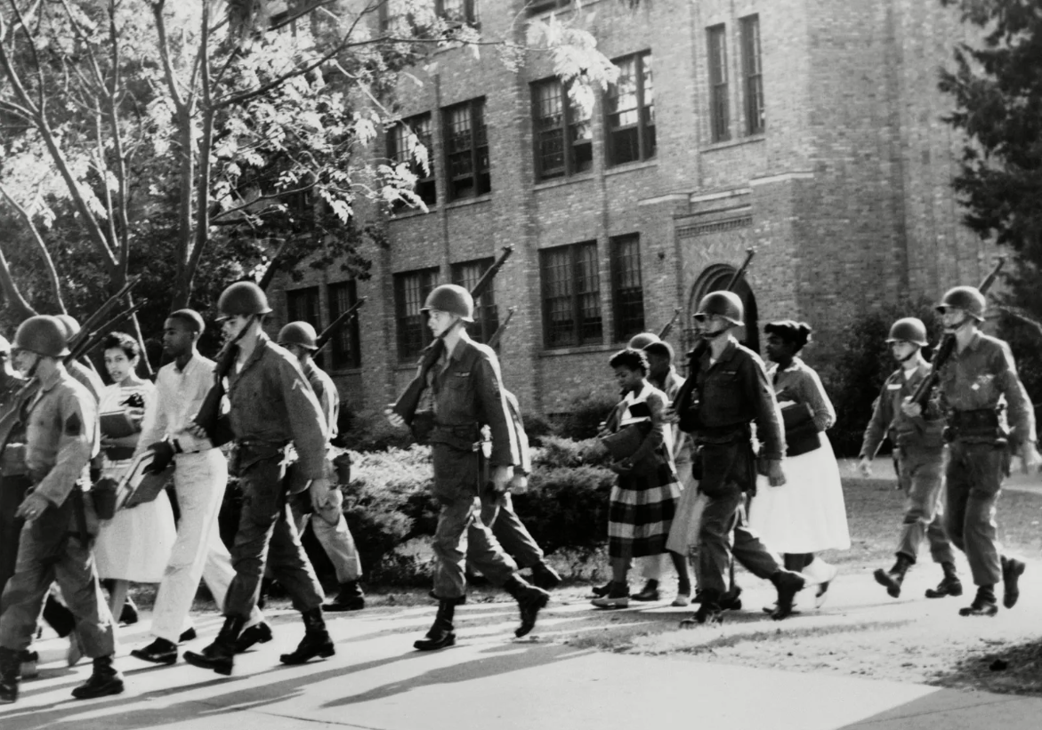 The Little Rock Nine being escorted by the National Guard, 1957.