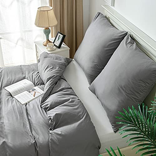 Graues Bettwäsche-Set in einem gemütlichen Schlafzimmer mit Nachttisch.